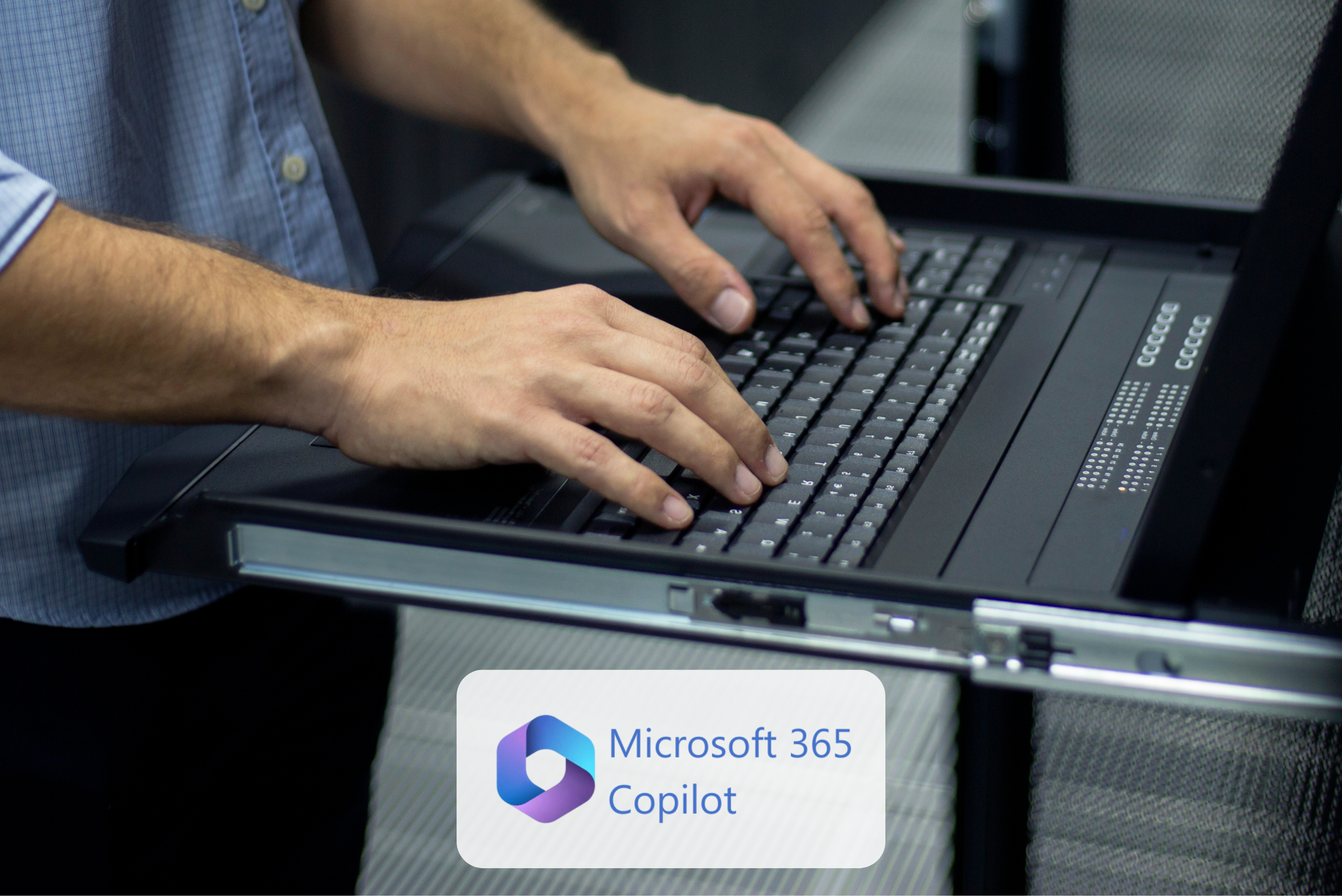 Male hands typing on a laptop with the Copilot logo below.