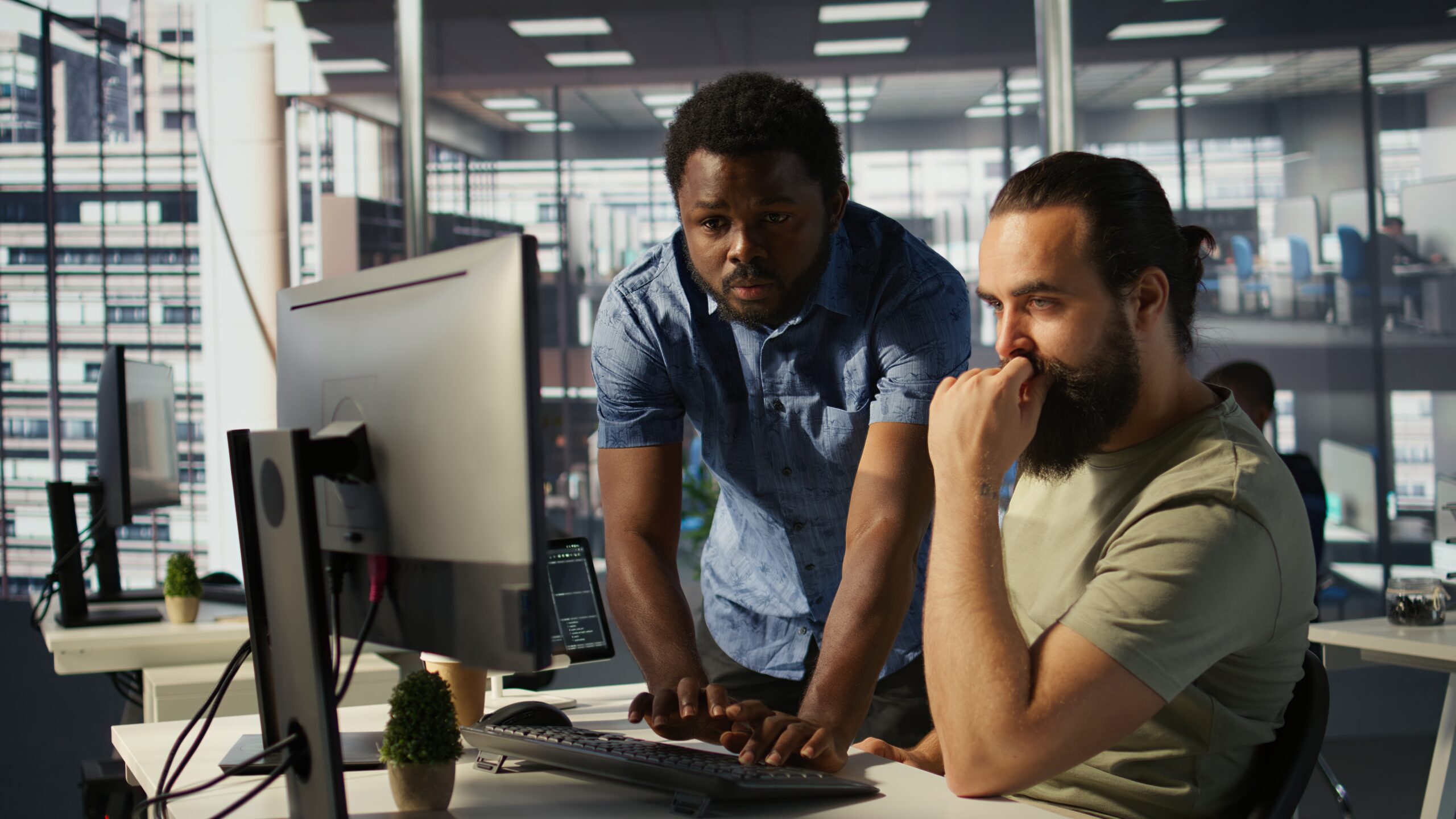 Business owner reviewing IT infrastructure issues on multiple computer screens